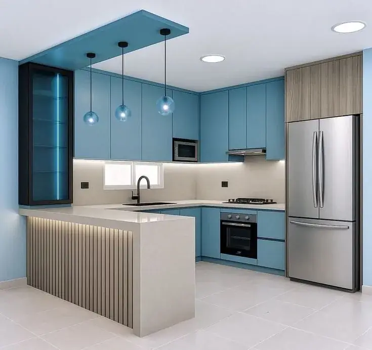 Blue fitted kitchen with pendant lighting and breakfast bar